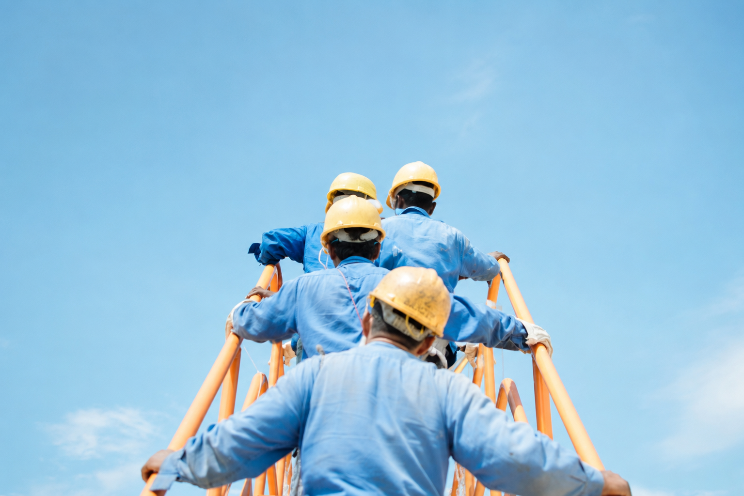 WASCO crew working at height under a clear sky